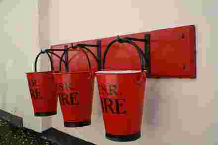 sand and water red buckets stand at fire post