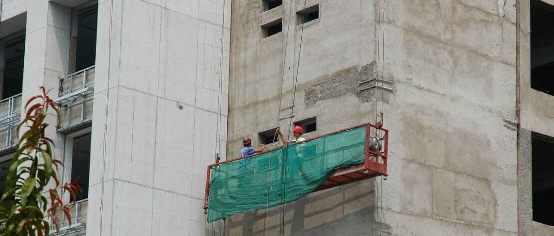 Worker works on industrial building